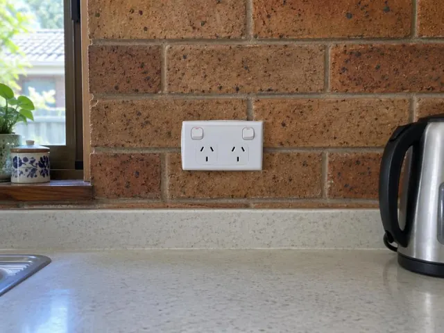 Double power point on a brick kitchen wall above a benchtop in Charlestown
